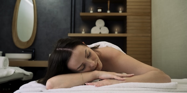 topless woman lying on bed