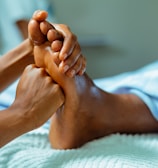 a person laying in a bed with their feet up